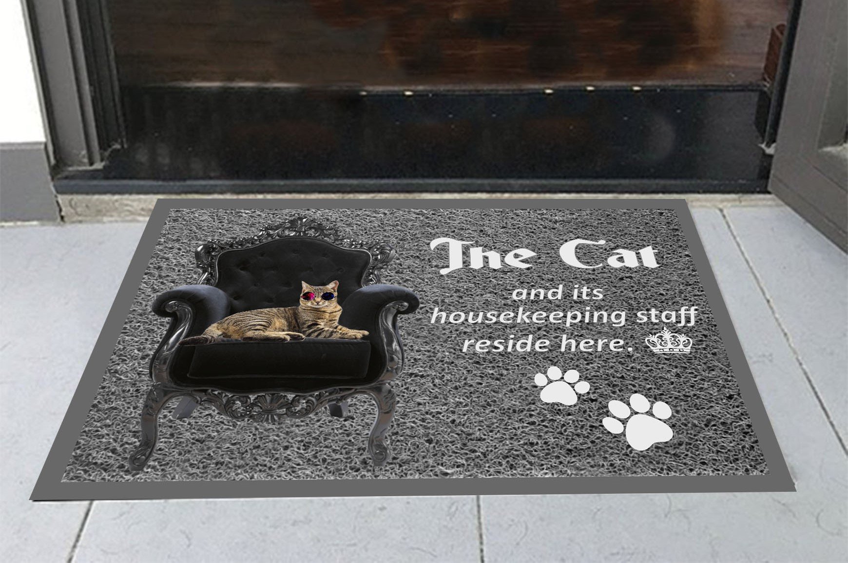 The cat and its housekeeping staff reside here doormat